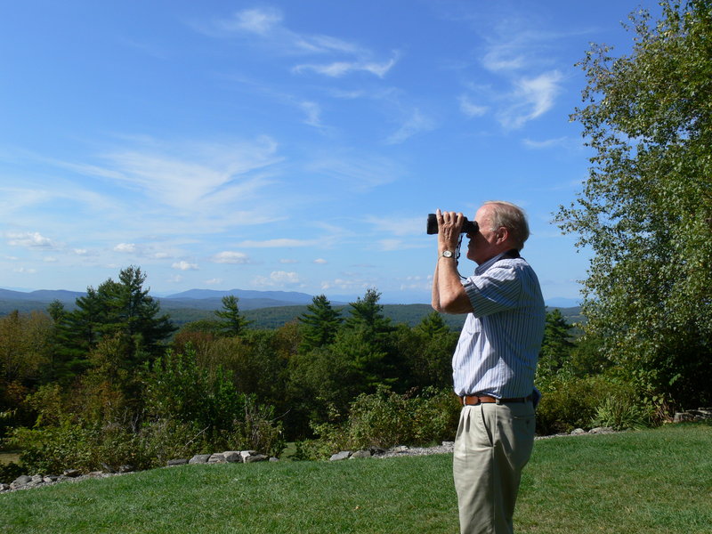 Dick Anderson, former Maine Audubon director, scans the skies around Hacker’s Hill in Casco for migrating hawks. Some 170 hawks were observed recently during a watch organized by Loon Echo Land Trust, a group seeking to preserve the parcel.