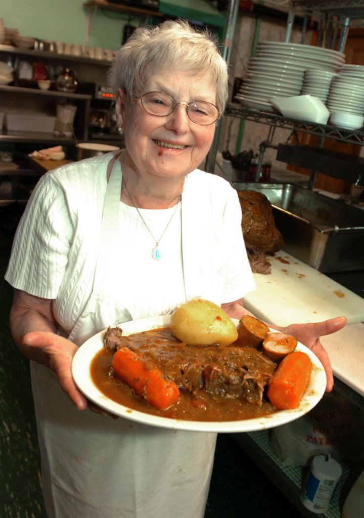 Ines De Costa shows off her New England pot roast with added Portuguese chiroco sausage in Fall River, Mass., in April 2008. Celebrity chef Emeril Lagasse, as a boy, liked to watch Mrs. De Costa in her restaurant kitchen and he maintained a loving, lifelong relationship with her.