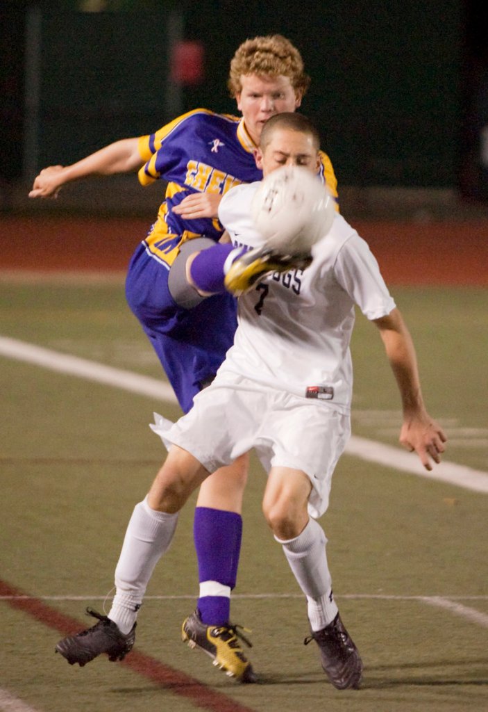 Jacob Smith of Cheverus wraps his foot around to knock the ball from Andrew Schwartz of Portland during Portland s 3-2 overtime victory Tuesday night.
