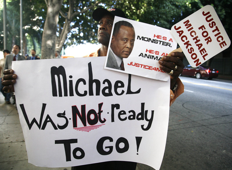 Bristre Clayton, a Michael Jackson fan from Las Vegas, shows his opinion outside court in Los Angeles on Tuesday during the opening day of Dr. Conrad Murray’s trial. Jackson’s personal physician is charged with involuntary manslaughter in the singer’s death from drugs in 2009.