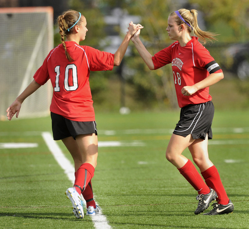 Haley Carignan of Scarborough, right, is greeted by Jessica Meader after scoring her first of three goals Wednesday in a 3-2 victory against Deering.