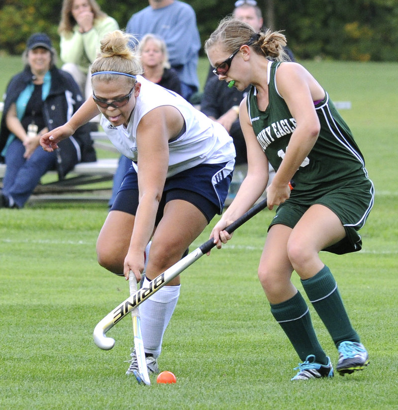 Kayla Winton of Westbrook, left, competes for the ball with Jordan Ray of Bonny Eagle during their field hockey game Wednesday. Westbrook scored in the second overtime to improve to 7-2 with a 2-1 victory at home.