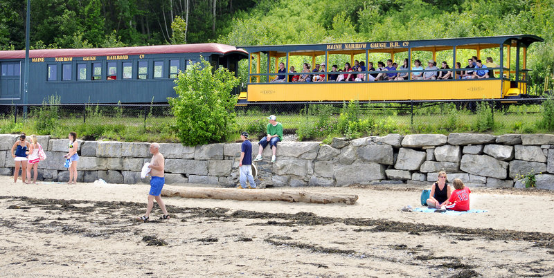 Passengers on the Maine Narrow Gauge Railroad take in a view of Portland’s East End Beach. The nonprofit is planning to relocate its museum and rail yard.