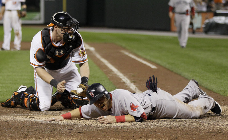 Marco Scutaro of the Boston Red Sox is out at the plate Wednesday night, tagged by Baltimore catcher Matt Wieters while trying to score in the eighth inning. The season ended for Boston, which went 7-20 in September to somehow miss the AL playoffs.
