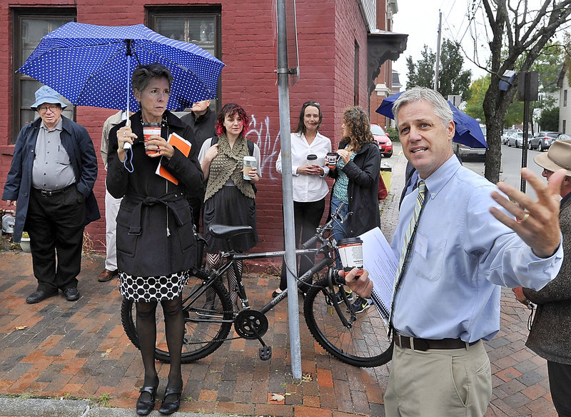 Tom Federle, right, representing S. Donald Sussman, leads members of the nonprofit Artspace development organization from Minneapolis and others from the Portland arts community on a tour of potential Artspace project locations Thursday. Here, they stand at Newbury and Hampshire streets, site of some properties owned by Sussman, a billionaire hedge fund manager.