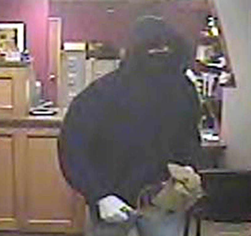 Contributed photo The person, shown in a security camera photograph, who robbed the HealthFirst Federal Credit Union in Waterville Thursday afternoon was in the building less than a minute, according to police.