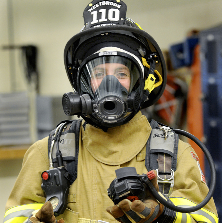 Megan Moody tries on full firefighter gear.