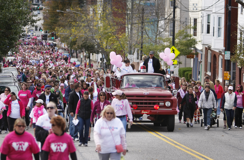 Participants in the American Cancer Society's annual Making Strides for Breast Cancer walk make their way up Congress Street to Munjoy Hill in Portland today.