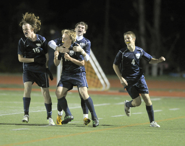 Michael Hickey, left, Theo Bullock, Pierce Twohig and Josh Mitchell of York celebrate Bullock’s goal early in the second half Monday night. The Wildcats (11-1-2) locked up the top seed in the Western Class B tournament. Yarmouth finished 9-4-1 and will be the No 2 or 3 seed.