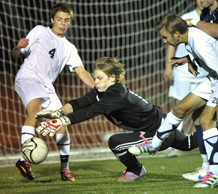 Yarmouth keeper Andrew Fochler dives for a loose ball as defender David Murphy, left, backs him up. Fochler made the start in place of Christopher Knaub, who was injured. Fochler’s stepbrother, Nathan Diffin, is York’s keeper.