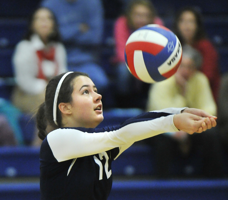 Grace Mallett of Yarmouth sets the ball to a teammate Wednesday during a straight-set volleyball playoff victory against Machias.