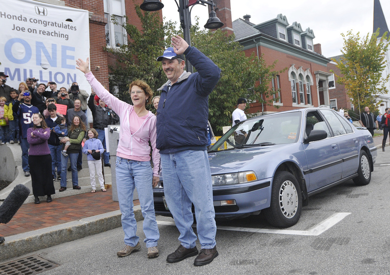 Joe LoCicero and his wife, Sharon, wave Sunday at a surprise parade in Saco to honor him for driving his 1990 Honda Accord, in background, over 1 million miles.