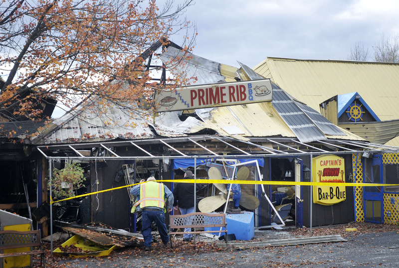 Saco Fire Chief John Duross and Dale Shannon of Saco’s public works department, ducking under the tape, go in to inspect the Steak N Rib Restaurant on Ocean Park Road in Saco, that was heavily damaged by fire early Sunday.