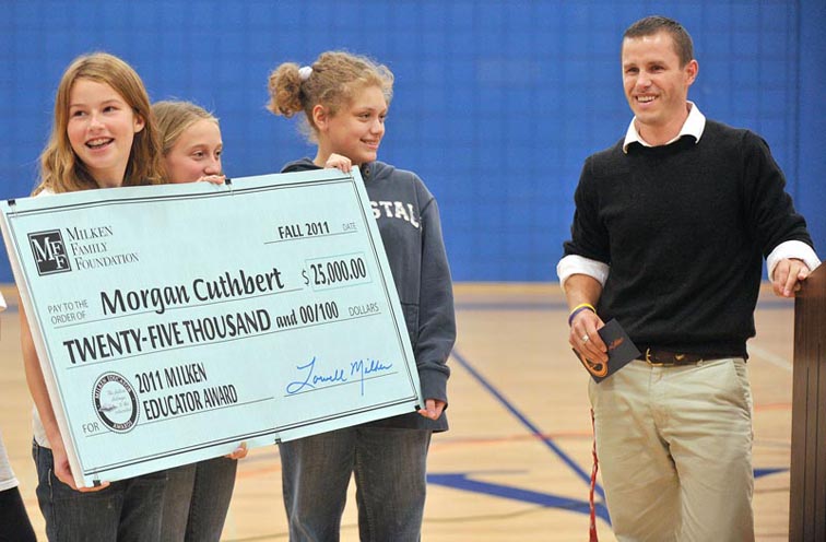Harrison Middle School students hold a check from the Milken Foundation made out to seventh-grade math and science teacher Morgan Cuthbert in Yarmouth today.