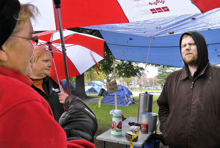 Jason Cook, right, a member of the group Occupy Maine, speaks with nurses Cokie Giles and Cathy Jo Herlihy today about life in the Occupy Maine encampment. Giles and Herlihy were part of a group of nurses, some from the Maine Nurses Association, who donated hats, blankets and medical supplies to the protesters..