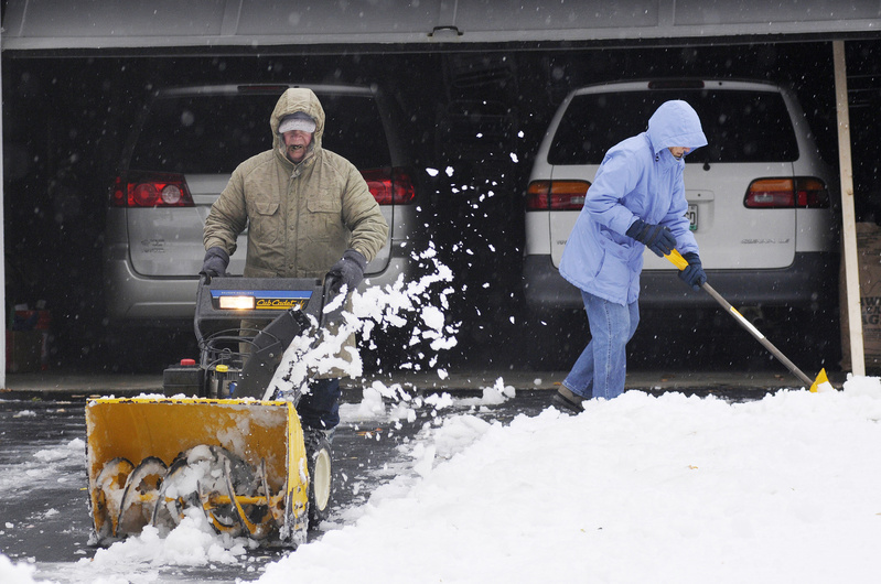 Jack Colpitts snowblows his Woodcock Avenue driveway in Saco as his wife, Anita, shovels a path in front of their garage today.