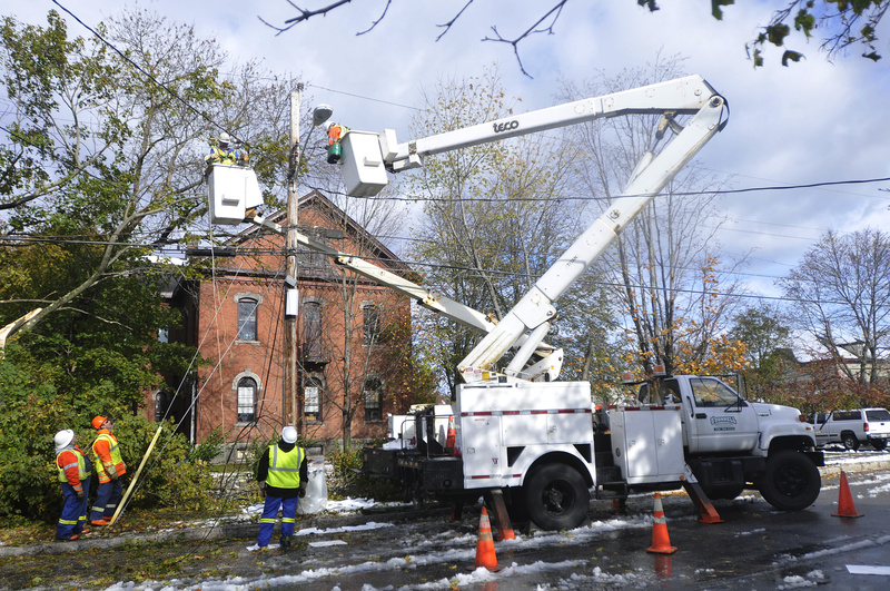 A crew from O'Donnell Line & Electric of Canada works to restore power on Dyer Street in Saco. A transformer was damaged after a tree fell on the line during today's storm causing power outages to the area.