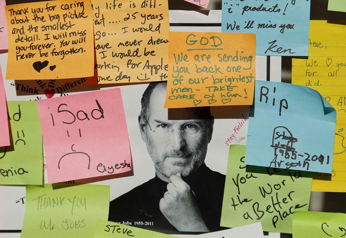 Notes written by mourners of the late Steve Jobs are posted outside an Apple store in Palo Alto, Calif., today.