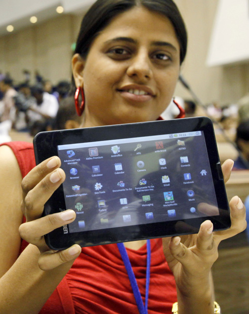 An Indian student poses with the supercheap Aakash tablet computer today. The Indian government intends to deliver 10 million tablets to students across India.