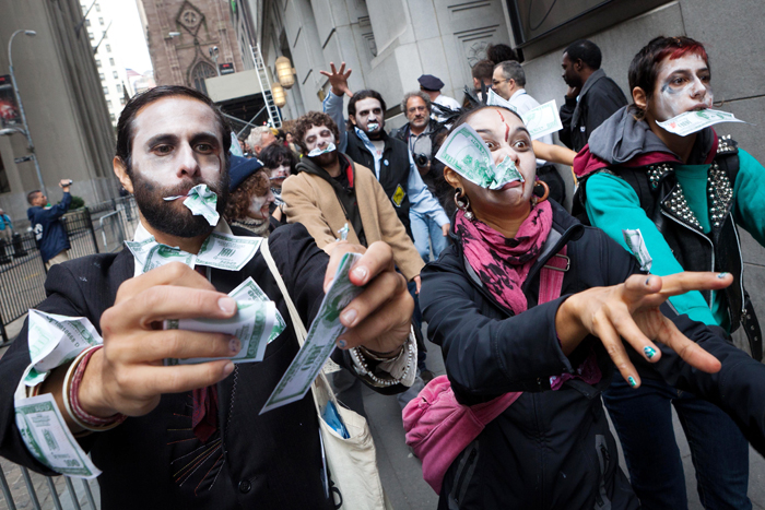 Protesters from Occupy Wall Street march through New York's financial district dressed as "corporate zombies" today.