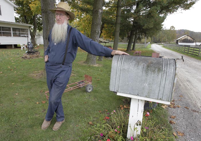 Sam Mullet, father of two of the three men arrested for allegedly going into the home of another Amish man and cutting his hair and beard, talks outside his home in Bergholz, Ohio, on Monday.