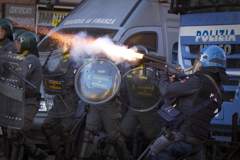 Italian police fire tear gas in Rome on Saturday as protesters turned a demonstration against corporate greed into a riot, smashing shop and bank windows, torching cars and hurling bottles.