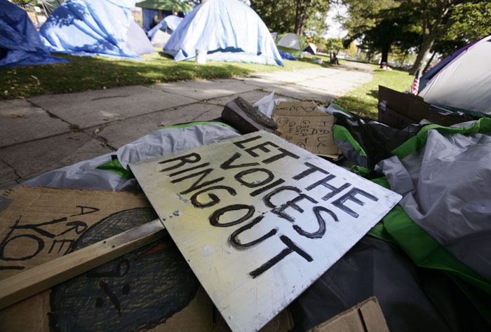 Rally signs are piled up at the encampment site for a group calling itself Occupy Maine in Lincoln Park in Portland.