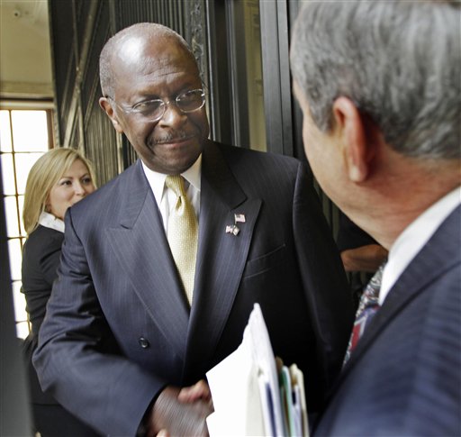 Herman Cain is greeted by lawmakers at the statehouse in Concord, N.H., on Wednesday.