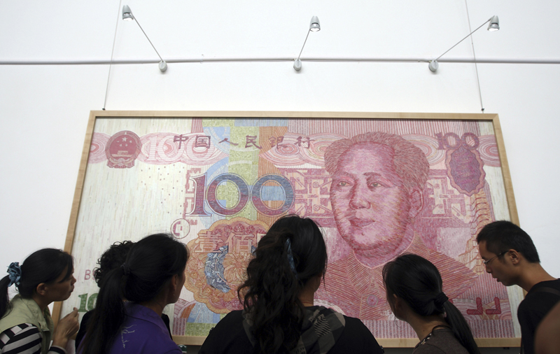 Visitors look at an artwork depicting a 100-yuan Chinese currency at the 2011 Chengdu Biennale in Chengdu, China. The Republican leader of the U.S. House of Representatives has dismissed a Senate bill that could punish China for undervaluing its currency.