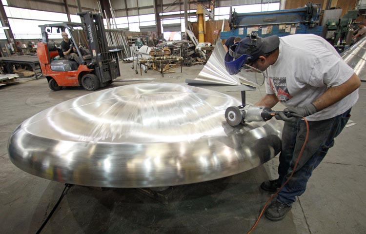 Chad Ipox grinds and polishes a stainless steel tank top at JV Northwest, in Canby, Ore., recently. JV Northwest manufactures stainless steel vessels. Manufacturing grew at a faster pace in September than the previous month, though the pace of growth was modest.