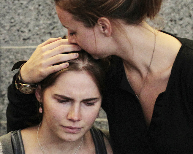Amanda Knox is comforted by her sister, Deanna Knox, during shortly after her arrival at Seattle-Tacoma International Airport on Tuesday.