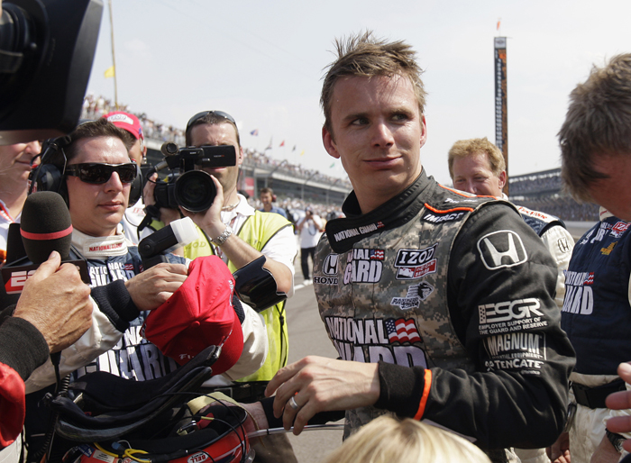 In this May 2010 photo, Dan Wheldon, speaks with reporters after finishing in second place in the Indianapolis 500 auto race at Indianapolis Motor Speedway in Indianapolis. Wheldon died Sunday in a 15-car wreck at Las Vegas Motor Speedway. He was 33.