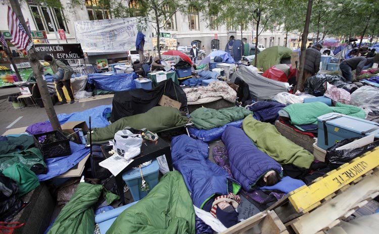 Occupy Wall Street protesters sleep in New York's Zuccotti Park on Sunday. With thousands of people roughing it in parks for up to six weeks related to the "Occupy" demonstrations, public health is a growing worry in the encampments.