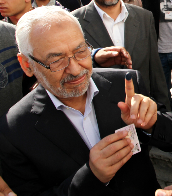 Rachid Ghannouchi, the leader of Tunisia's main Islamist party Ennahda, shows his ink-stained finger after voting in Menzeh near Tunis on Sunday.Tunisians began voting Sunday in their first truly free elections.