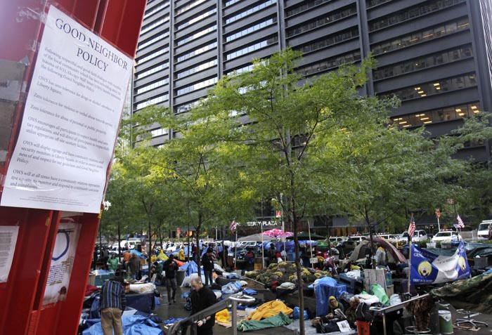 A "Good Neighbor Policy" is posted in Zuccotti Park where Occupy Wall Street protesters start their day in front of a building owned by Brookfield Properties in New York.