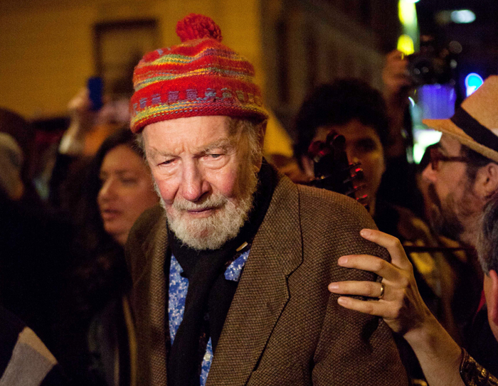 Pete Seeger, 92, exits the Symphony Space on the Upper West Side to march with nearly a thousand demonstrators sympathetic to the Occupy Wall Street protests for a brief acoustic concert in Columbus Circle on Friday.