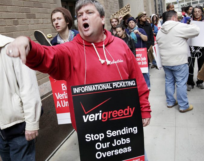 Kevin Condy and other picketing Verizon employees are joined by Occupy Wall Street protesters in front of a Verizon office in New York on Tuesday.