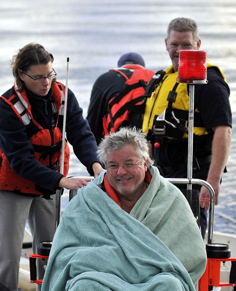 Staff photo by Michael G. Seamans Rescue personel from Oakland, Smithfield and Belgrade responded to a boat accident on North Pond just after 4pm Wednesday. The victim was transported to Inland Hospital in Waterville.