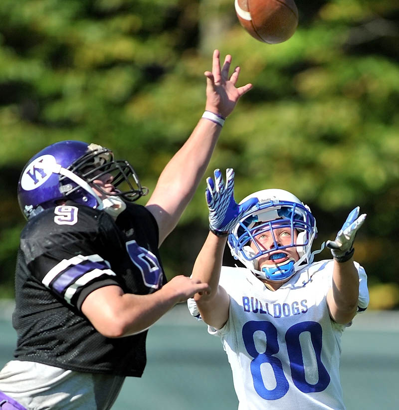 Staff photo by Michael G. Seamans Waterville High School defender J.T. Whitten, 9, breaks up a pass to Madison High School's Kyle Demchak, 80, in the third quarter at Waterville Senior High School Saturday. Waterville defeated Madison 55-36.