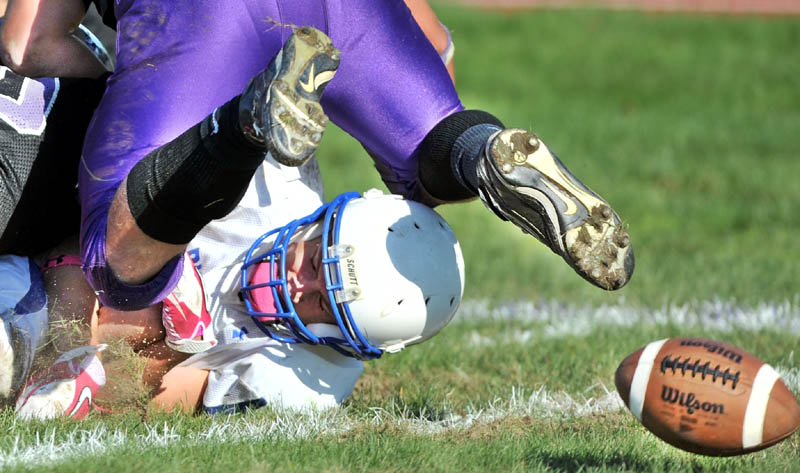 Staff photo by Michael G. Seamans Madison High School's Stephen Cusson, 15, fumbles the ball near the goal line against Waterville High School at Waterville Senior High School Saturday. Madison recovered the loose ball in the end zone for a touchdown. Waterville defeated Madison 55-36.