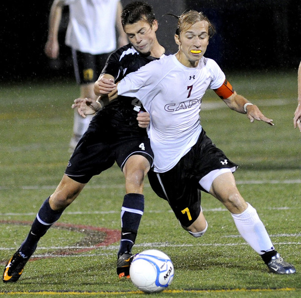 Blake Barritt of Cape Elizabeth attempts to control the ball and hold off David Murphy of Yarmouth during their Western Maine Conference soccer game Tuesday night. Yarmouth held on for a 1-0 win.