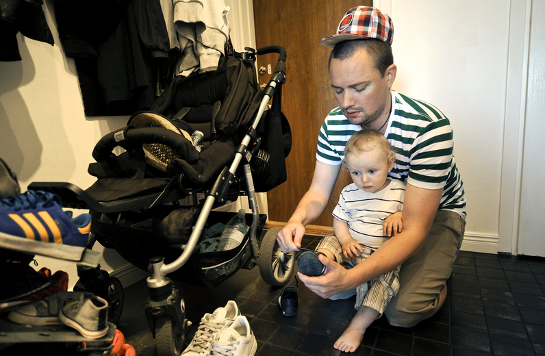 Henrik Holgersson dresses his son, Arvid, at their Stockholm home. Holgersson, who has split Sweden’s parental leave with his girlfriend, is spending eight months at home with their child. The share of parental leave time taken by Swedish men nearly doubled from 2000 to 2010.