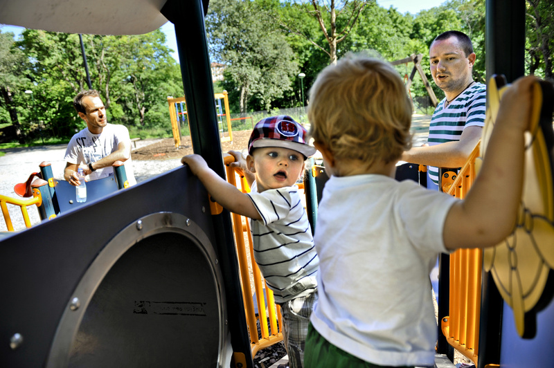 Henrik Holgersson, right, watches his son, Arvid, at center in hat, play with Walter Johansson, accompanied by his father, Henrik Johansson, at a playground in Stockholm.