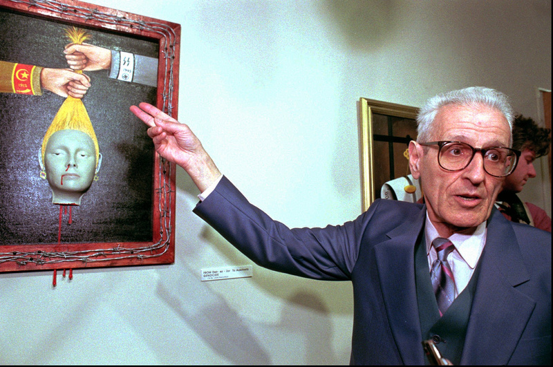 Dr. Jack Kevorkian discusses “Genocide” at his show in Royal Oak, Mich., in 1997. More than 20 of his paintings will be sold.
