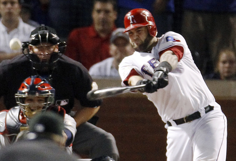 The Rangers’ Mike Napoli hits a two-run double off St. Louis pitcher Marc Rzepczynski in the eighth inning Monday night in Arlington, Texas, in Game 5 of the World Series. Texas started its rally with solo homers by Mitch Moreland in the third and Adrian Beltre in the sixth.