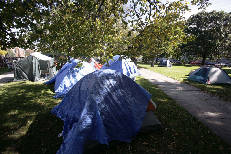 CAMP OUT FOR CHANGE: Tents are arranged Tuesday at an encampment site for a group calling itself OccupyMaine in Lincoln Park in Portland. The group, which started as an offshoot of an Occupy Wall Street demonstration, has been holding signs and offering information on what they call corporate greed, political corruption and the need for change at Monument Square in Portland.