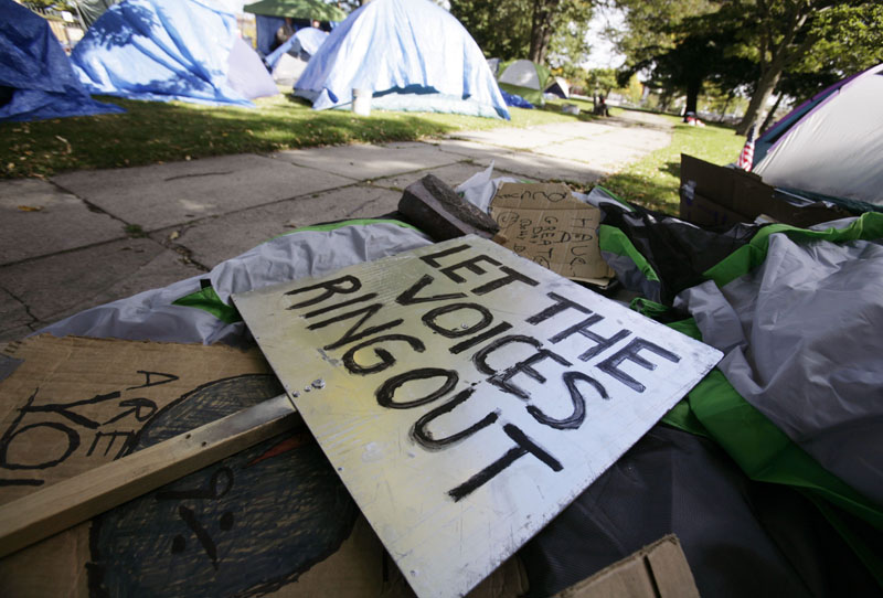 NO BACKING DOWN: Rally signs pile up in an encampment site for OccupyMaine on Tuesday in Portland. What began as a three-day demonstration has turned into a cause for those living in the camp. Some jokingly call it “Hooverville” in reference to the popular name for the shanty towns named for President Herbert Hoover and built by homeless people during the Great Depression.