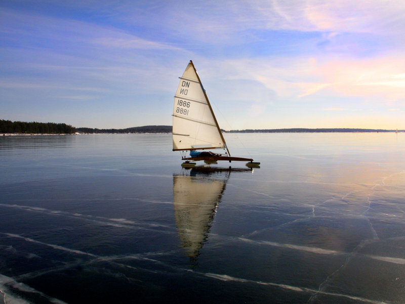 An ice boater sails on Sebago Lake in a DN class boat.