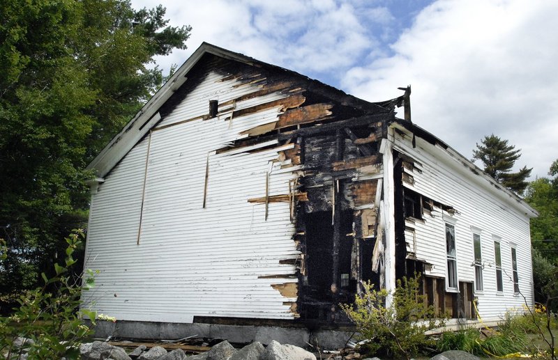 The Raymond Hill Baptist Church shows damage from an arson fire in this July 27 photo. A Standish woman is charged with setting that fire and two others.