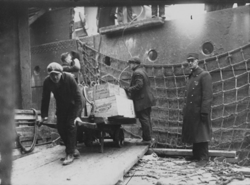 Officials remove illegal liquor from a ship docked at the Grand Trunk Wharf in Portland Harbor in the 1920s. Prohibition became law nationwide with the 18th Amendment in 1919.
